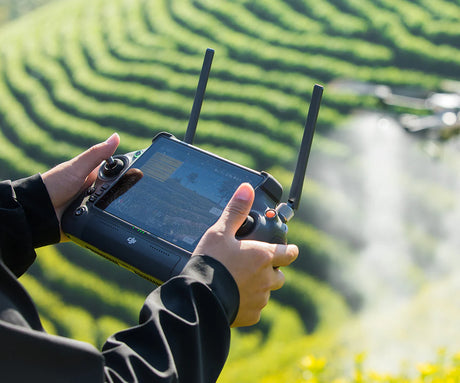 Person holding Agras T50 RC drone controller
