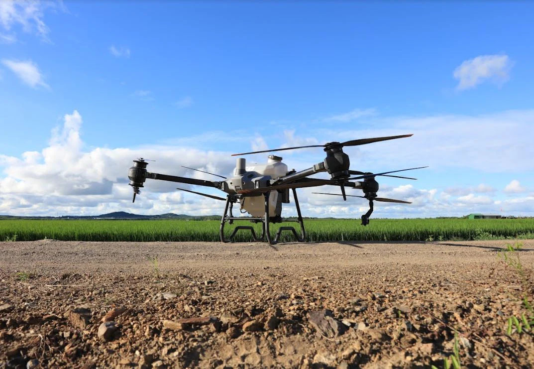 Large DJI AGRAS T40 Agricultural Drone on a dirt surface