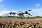 Large DJI AGRAS T40 Agricultural Drone on a dirt surface