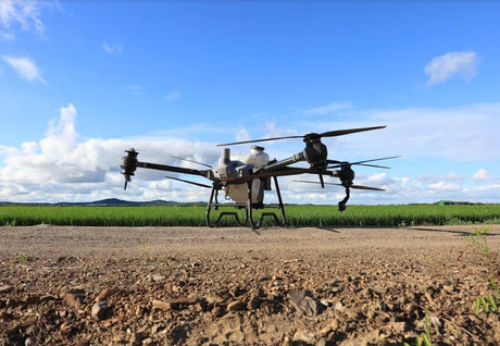 Large DJI AGRAS T40 Agricultural Drone on a dirt surface